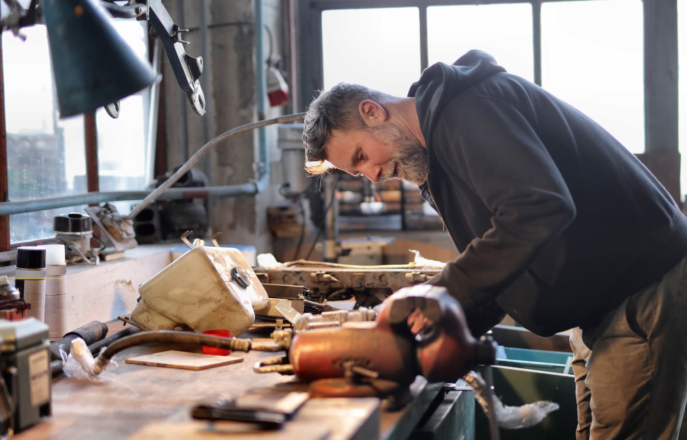 Mechanic working on an engine in a garage