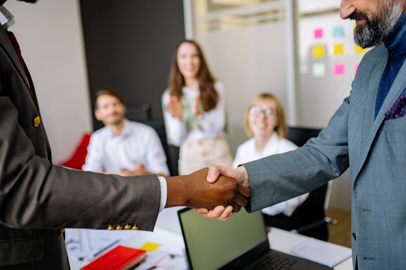 Two professionals shaking hands in an office